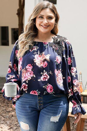 a woman wearing ripped jeans and a floral top