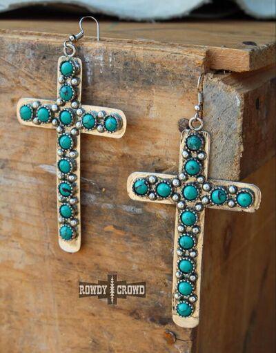 a pair of cross earrings with turquoise stones