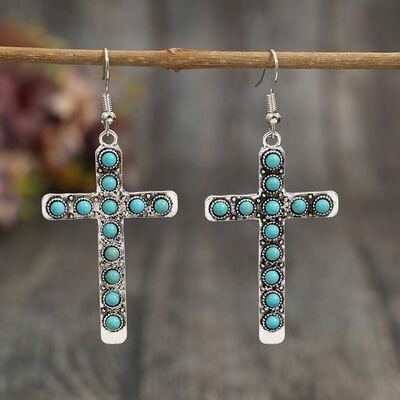a pair of cross earrings with turquoise stones