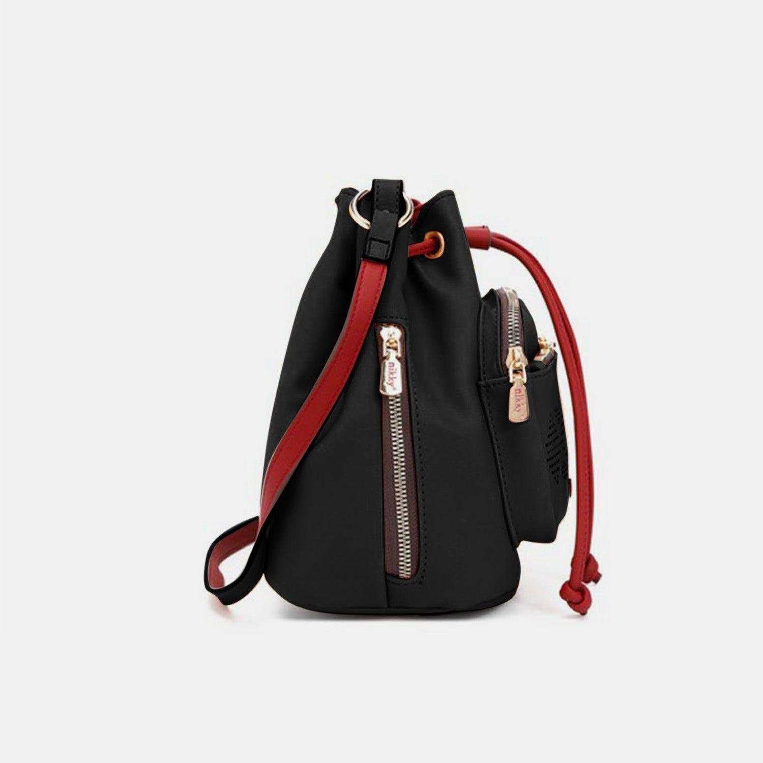 a small black bag with a red strap