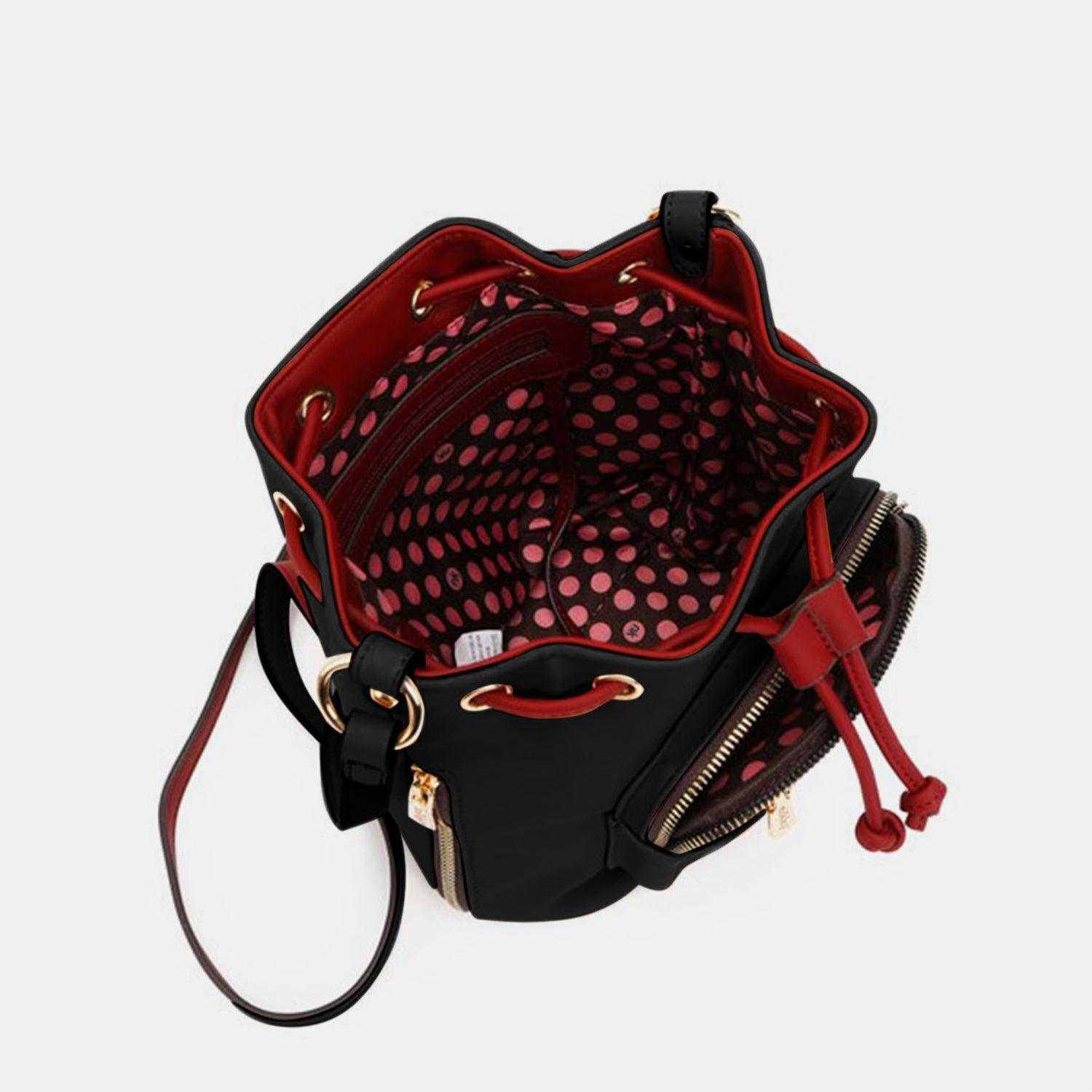 a black and red handbag with a red handle