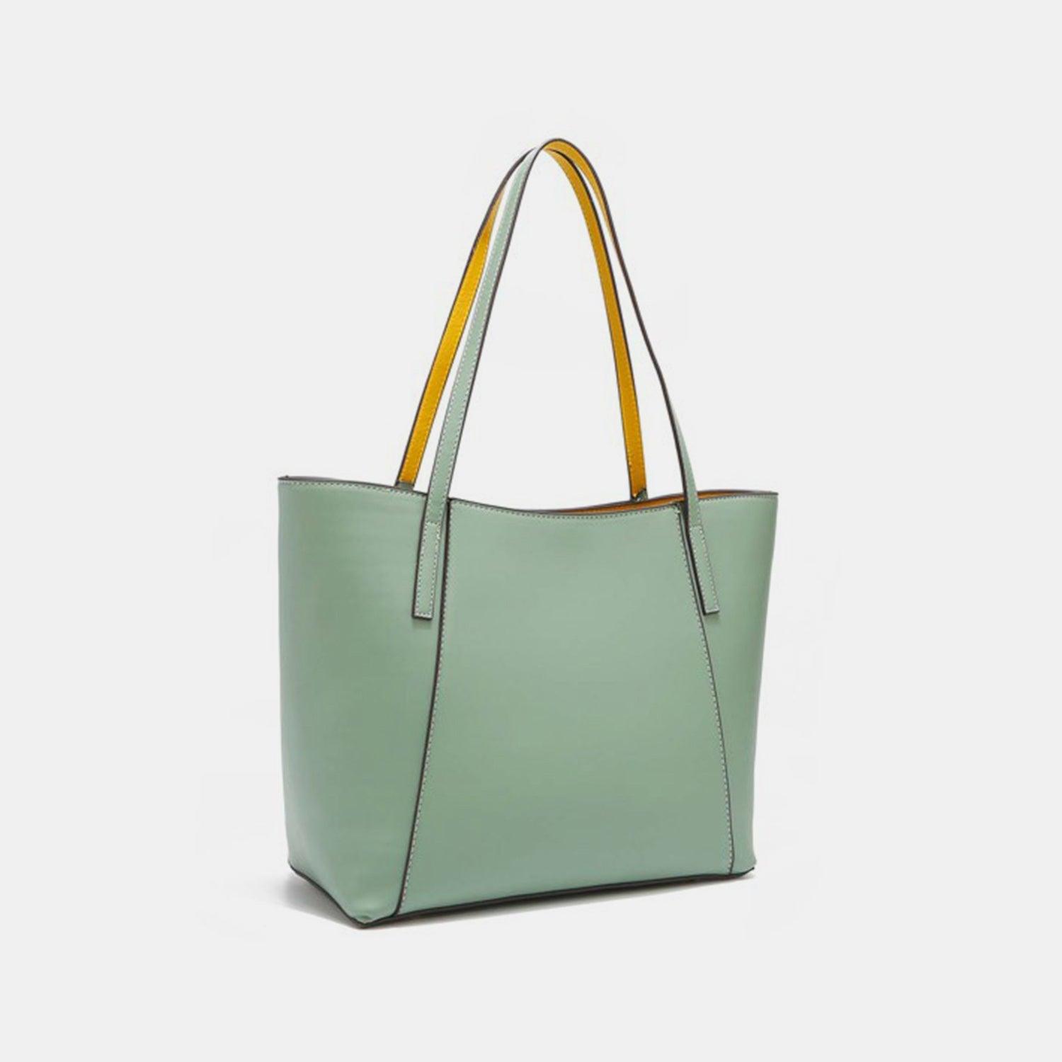 a green tote bag with a yellow handle
