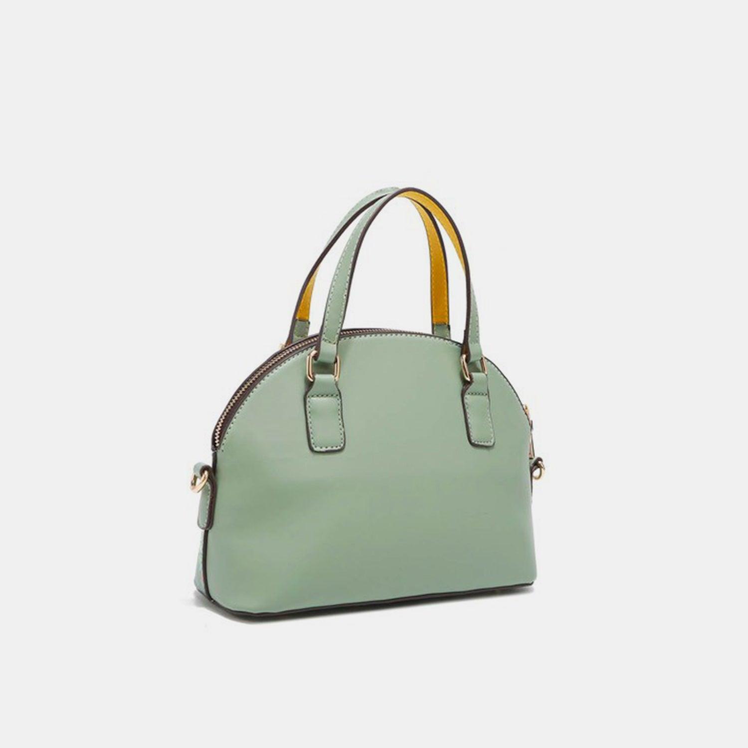 a green handbag with a yellow handle