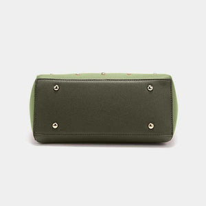 a green purse with rivets on the front