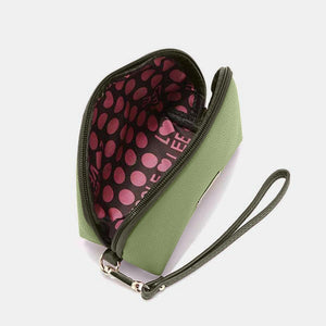 a green purse with pink polka dots on it