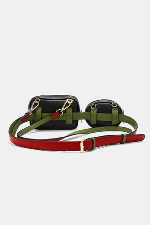 a black and green belted bag with a red strap