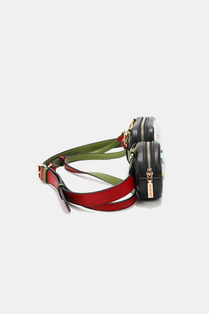 a small black purse with a red and green strap