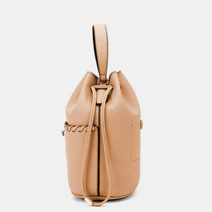 a tan leather bucket bag on a white background