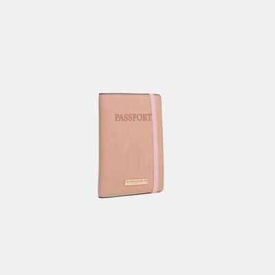 a pink passport case sitting on top of a white surface