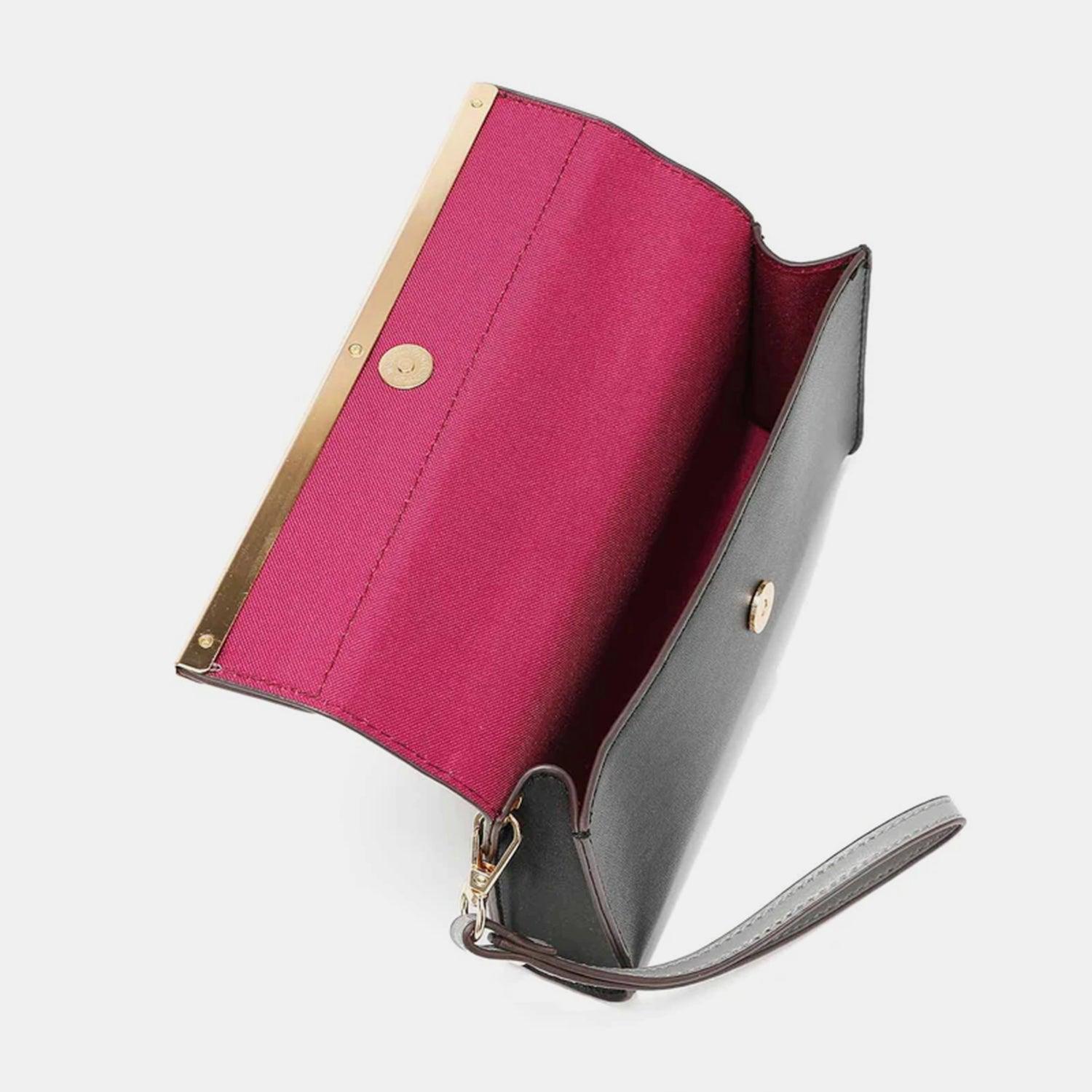 a pink and black purse with a gold handle