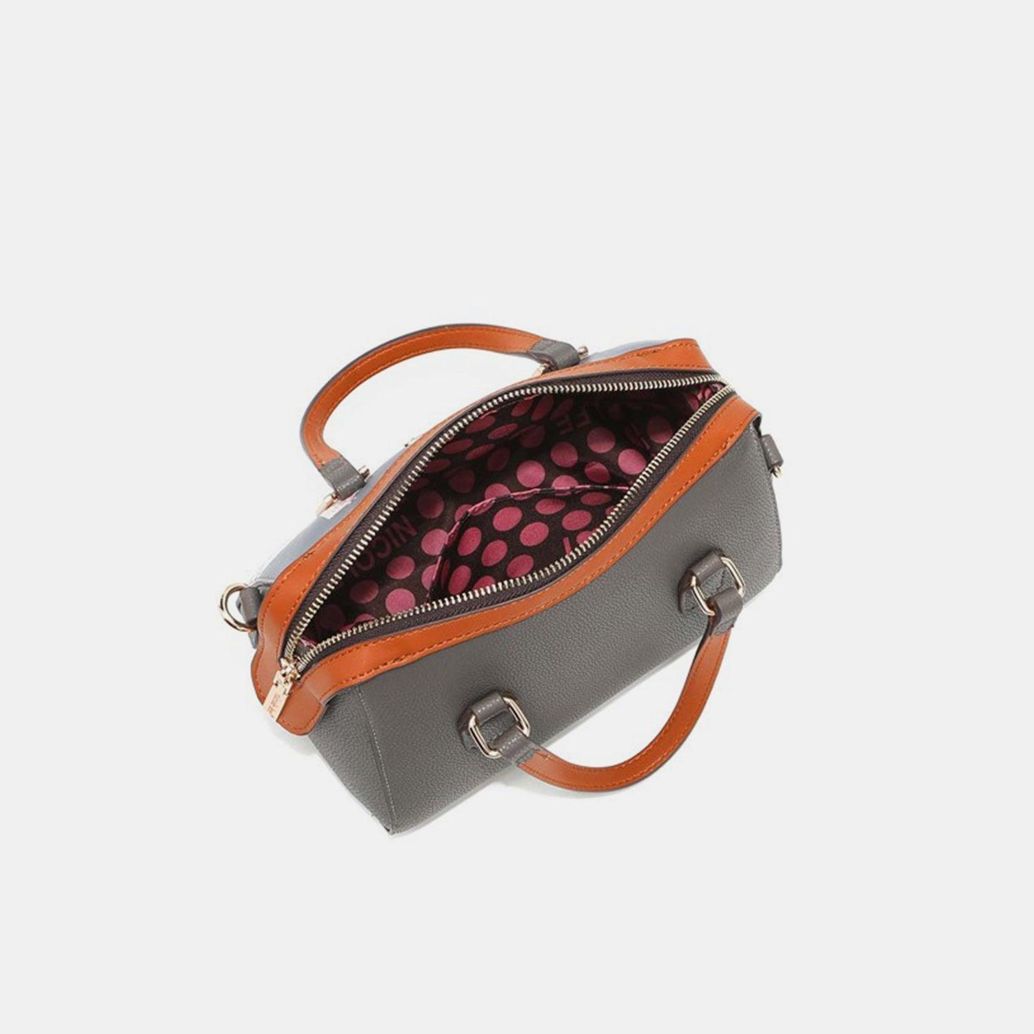 a gray and orange handbag with a polka dot design