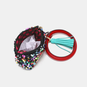 a small purse with a tassel and a ring
