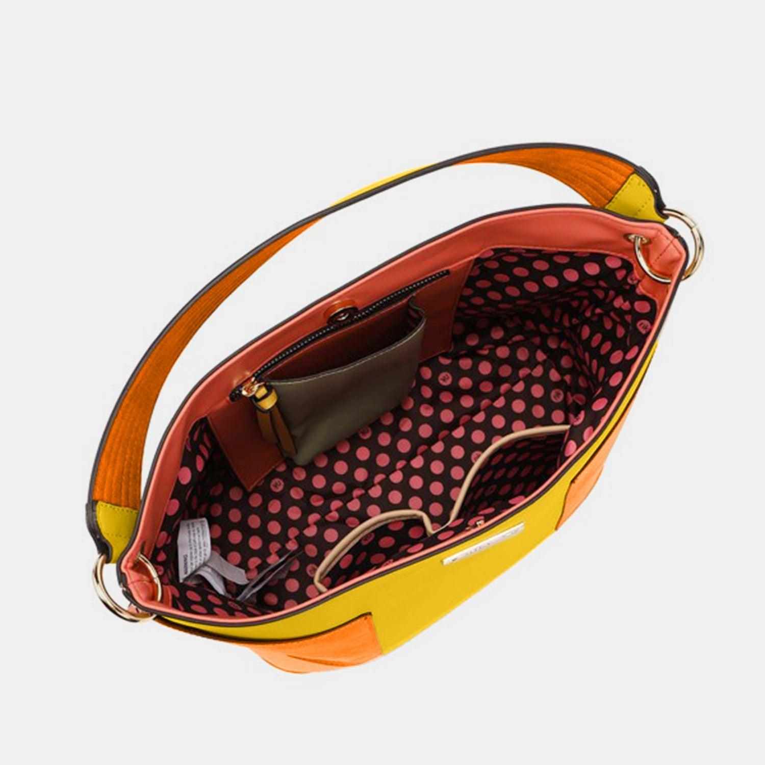 a handbag with a yellow handle and a polka dot pattern