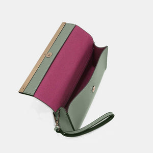 a green and pink purse sitting on top of a white table