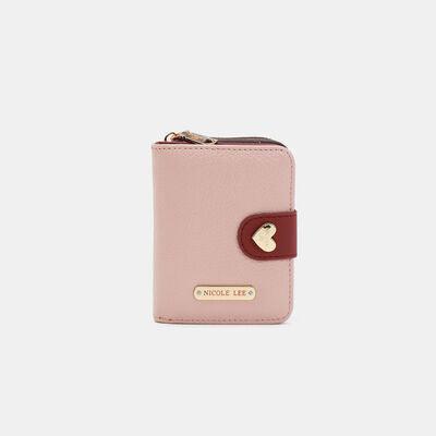 a pink wallet with a gold heart on the front