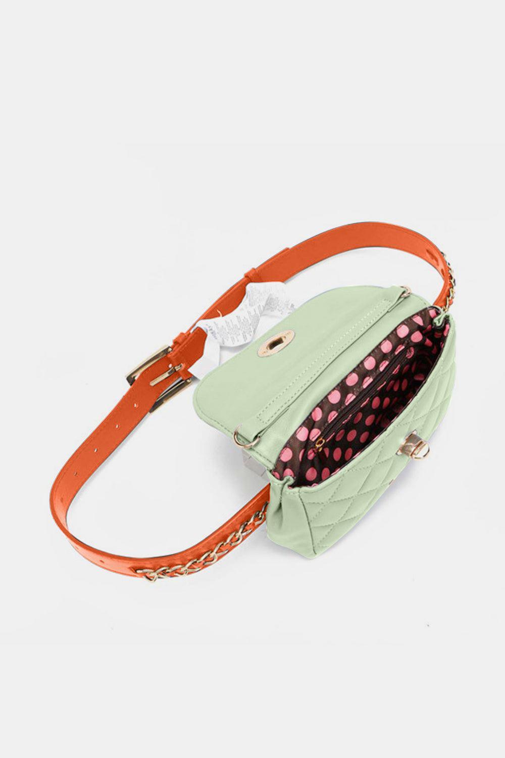 a small green purse with a red handle