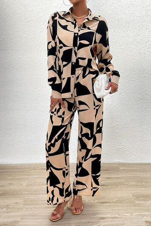 a woman in a black and white print jumpsuit