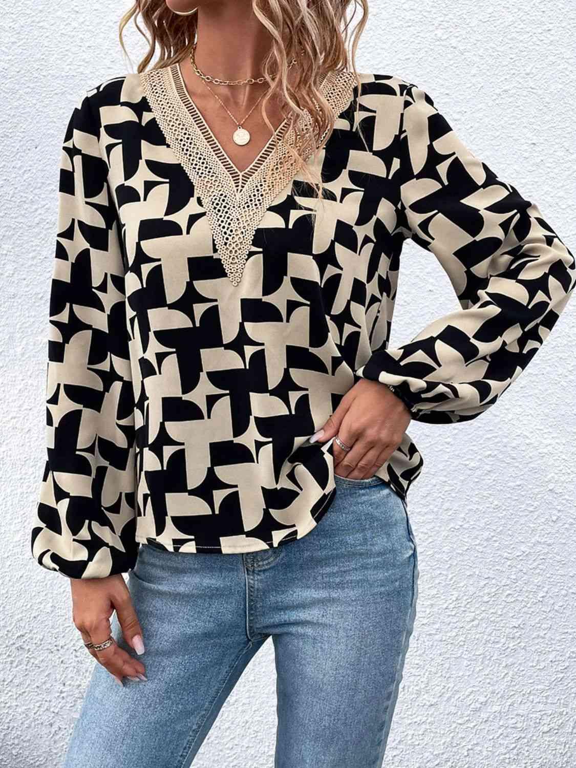 a woman wearing a black and white blouse