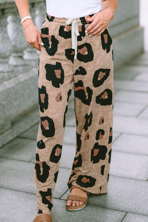 a person standing on a sidewalk wearing a pair of leopard print pants