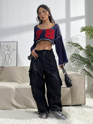 a woman in a crop top and cargo pants