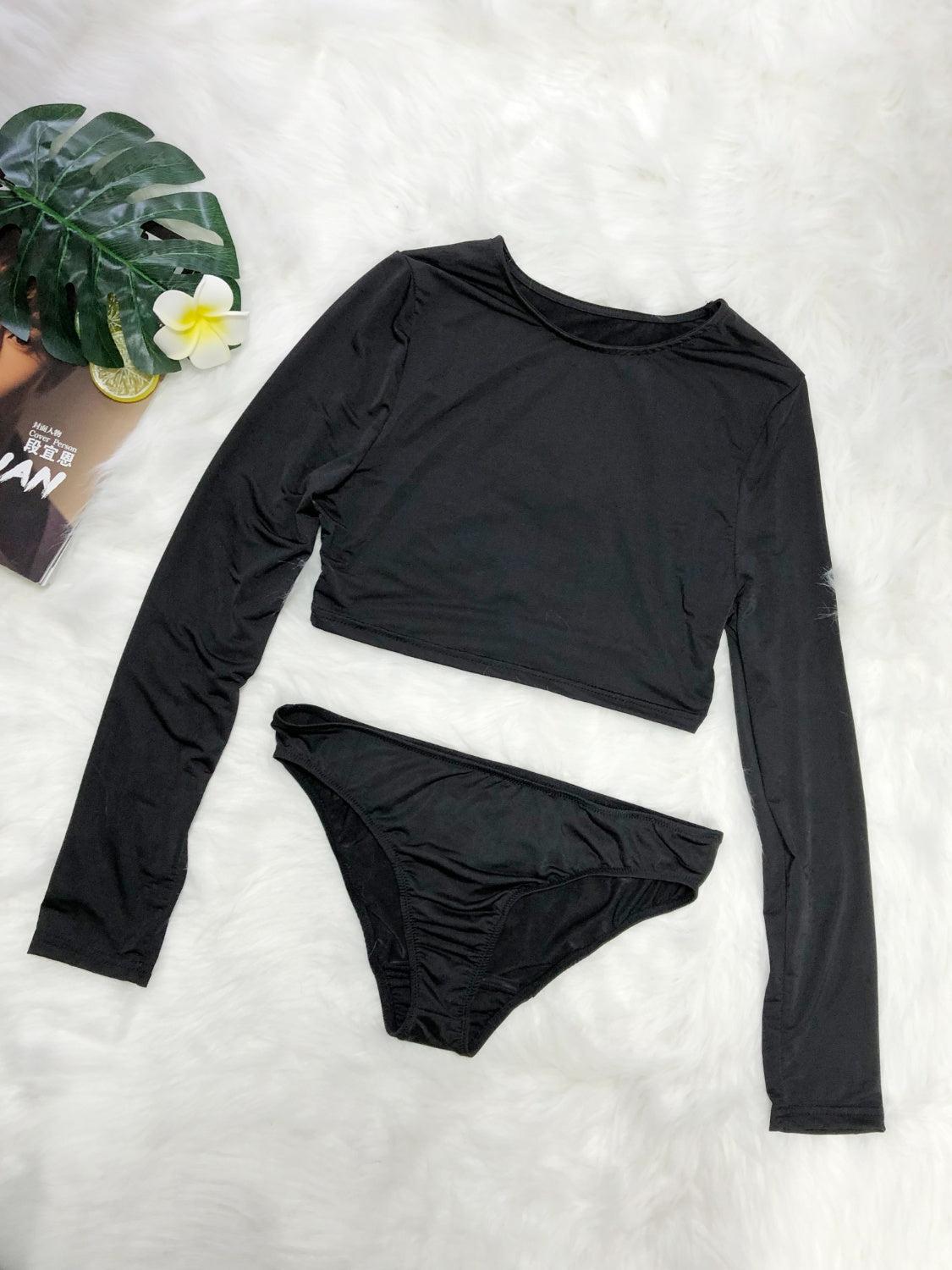 a woman's black bikinisuit and a plant