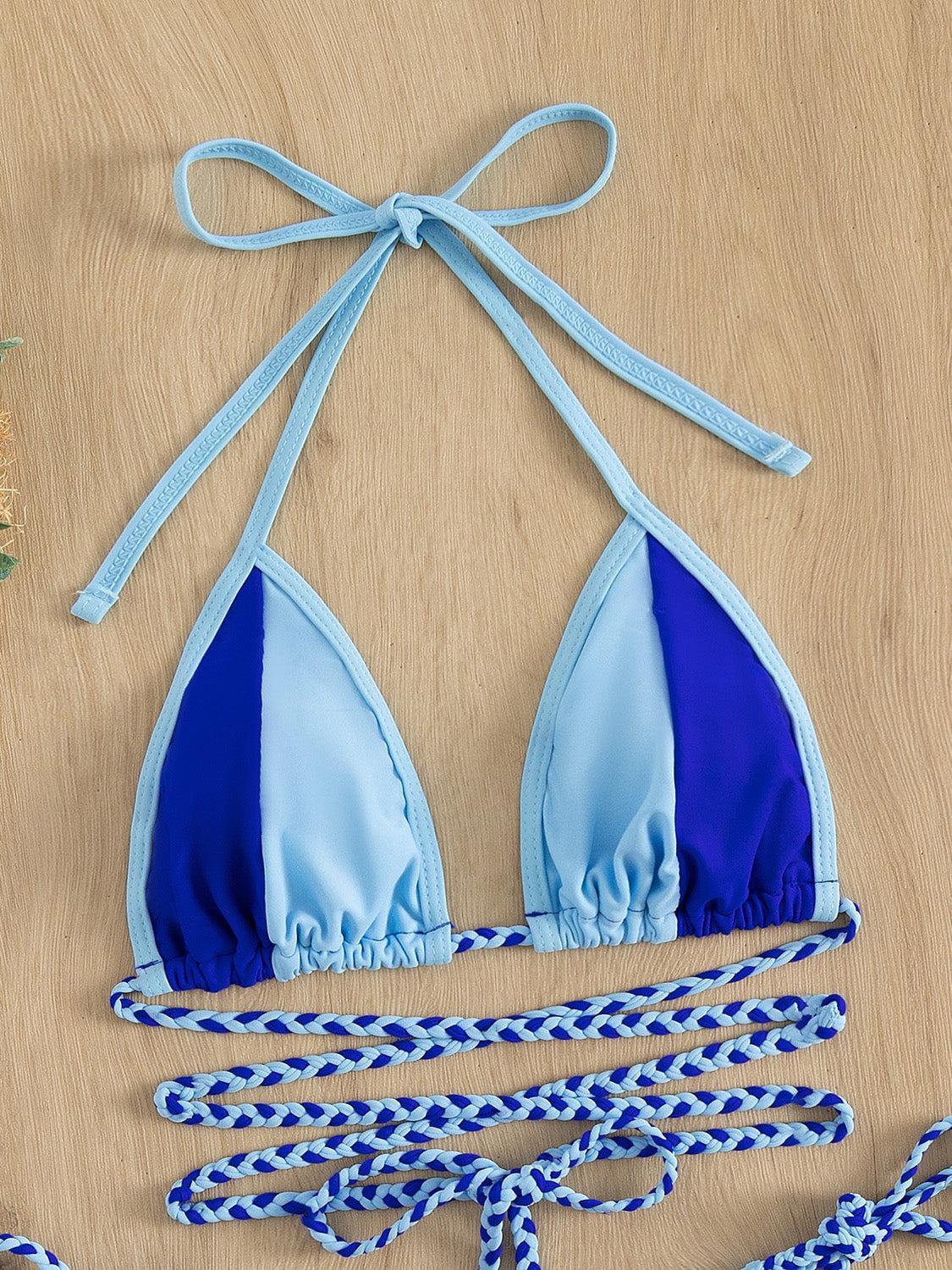 a blue and white bikini top with a knot tied around it