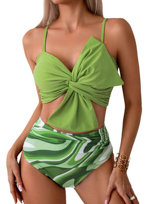 a woman wearing a green bikini top with a bow