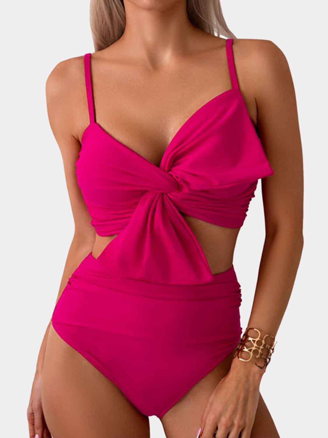 a woman in a pink one piece swimsuit