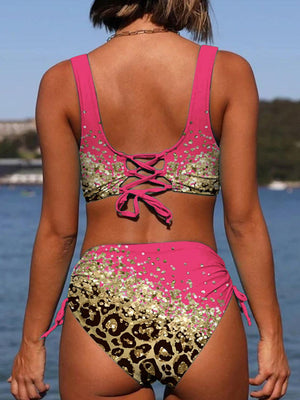 a woman in a pink bikini top and leopard print bottom
