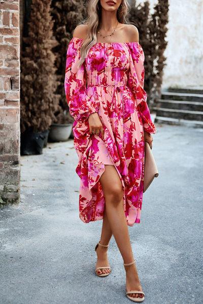 a woman in a pink floral print dress