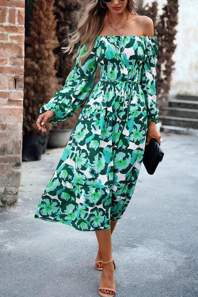 a woman in a green floral print dress