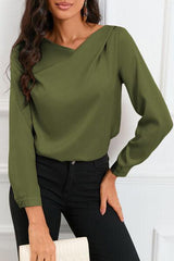 a woman wearing a green blouse and black pants