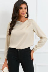 a woman in black pants and a beige top