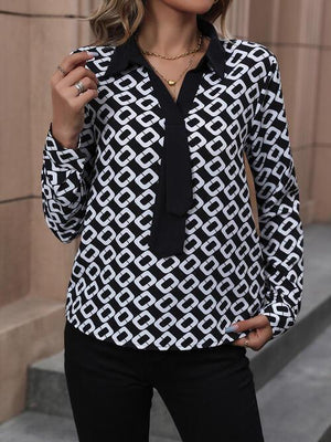 a woman wearing a black and white shirt and tie