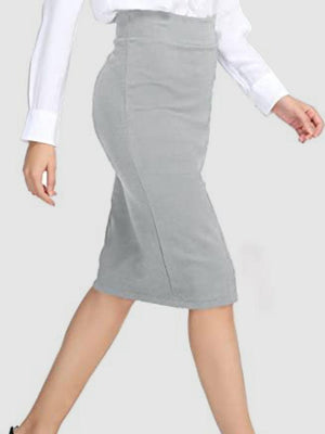 a woman in a white shirt and grey skirt