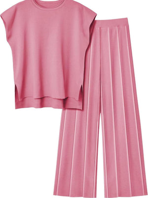 a pink crop top and pleated pants