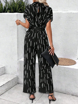 a woman wearing a black and white jumpsuit