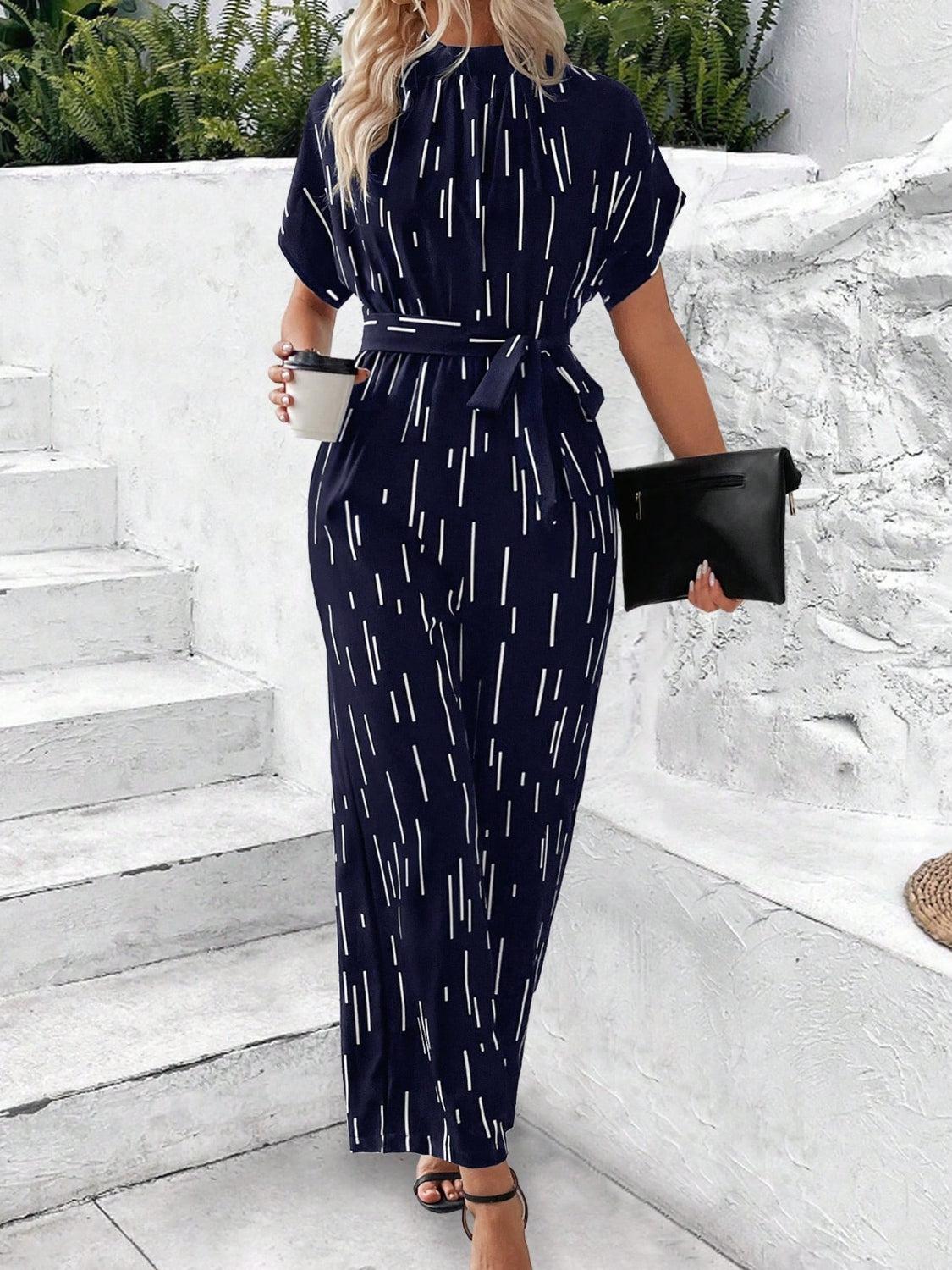 a woman in a black and white print jumpsuit