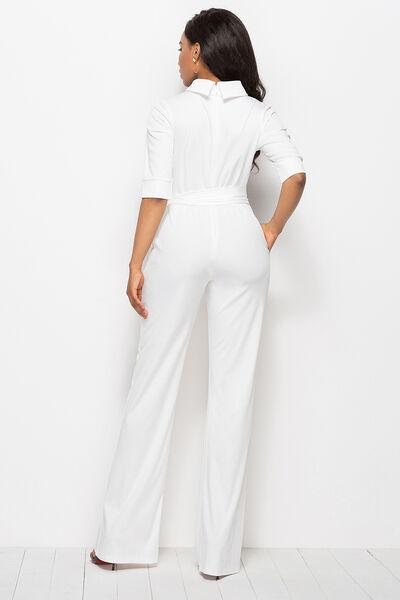 a woman wearing a white jumpsuit and heels