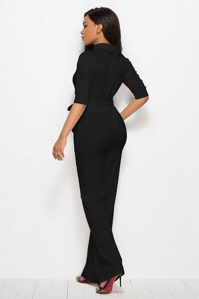 a woman in a black jumpsuit and heels