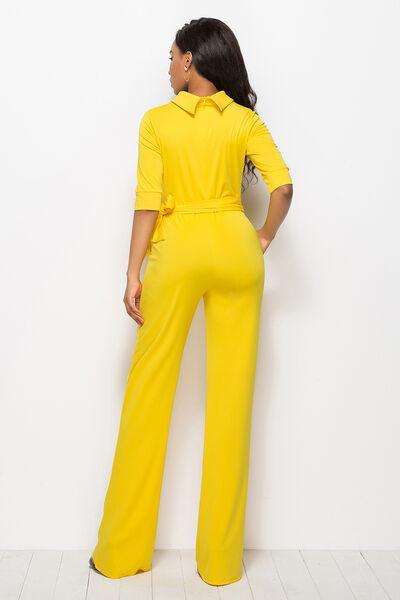 a woman in a yellow jumpsuit standing up