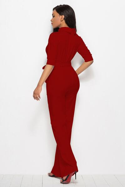 a woman in a red jumpsuit and heels