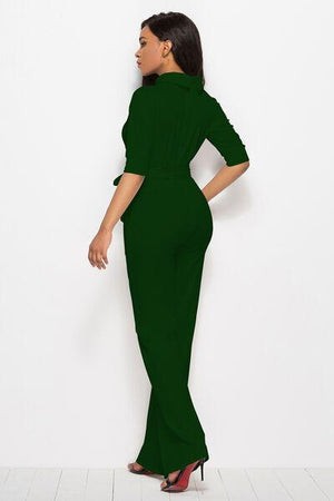 a woman in a green dress standing up