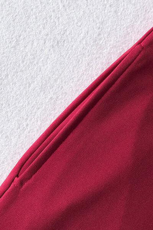 a close up of a red pants on a white surface