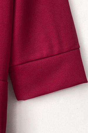 a close up of a red shirt on a hanger