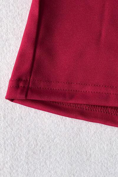 a close up of a red shirt on a white surface