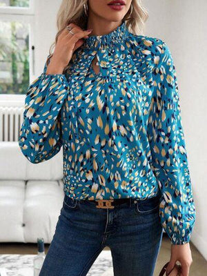 a woman wearing a blue blouse and jeans