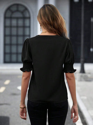 a woman walking down the street wearing a black top