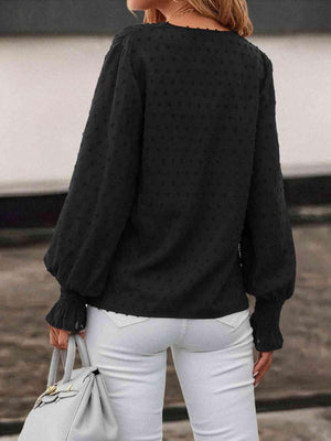 a woman wearing white jeans and a black top