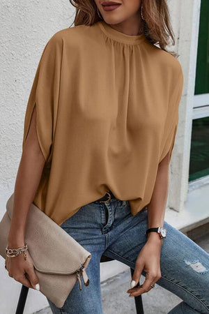 a woman sitting on a chair holding a purse